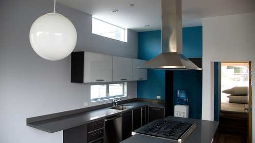 In designing smaller kitchen spaces, focus on function, making things open and light and use of color and design elements to maximize space and keep it from feeling too confined.