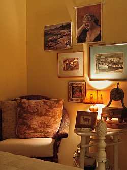 Fine art and warm walls give this living room a cozy feeling.