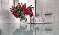 A glass slab or glass tile countertop can give the bathroom an elegant, polished smooth or bright and colorful design, depending on your preferences.