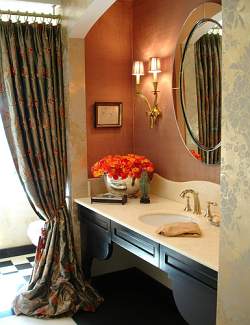 Soft curves and a brass finish match the feminine design of this makeup vanity.