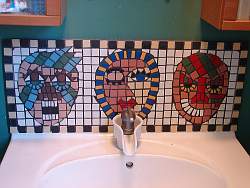 Unique features such as this tile mosaic of primitive faces add interest to a boys bathroom theme.