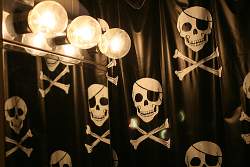 A shower or bathtub curtain like this pirate skulls design is one of the easiest ways to decorate a boys bathroom.