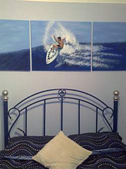 Wall art will be the cheapest way to give your boys bedroom a beach or surfter theme.