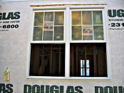 Windows and doors go in place before roofing begins.