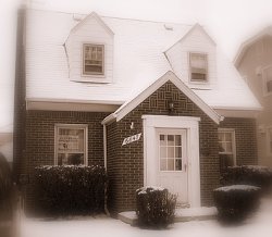 In the early to mid 20th century, simple cape cod style homes  became very popular, with brick or wood siding, steep roofs to shed ice and snow, and cheap to build.