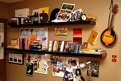 Shelves display musical memorabilia, instruments and a collection of favorite CD and DVD discs, making a nice decorative display in a teen bedroom.