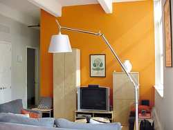 Paint a single wall in orange or another bright fall color and leave the rest white for strong contrast.