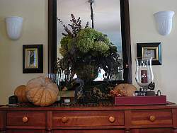 A sideboard, dislay shelves, end table or coffee table can be transformed with colors and hints of autumn.