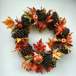 Pine cones and miniature pumpkins give this autumn wreath great form and color contrast.