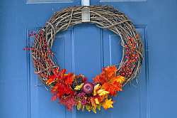 Using woven branches, berries and bright fall flowers and fruits, a fall wreath can be made using whatever natural materials you can find in your area during the autumn season.