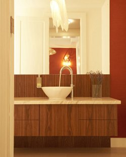 Make the vanity in your guest bathroom a visual focal point; choose sink basin, fixtures and materials to achieve your desired theme.