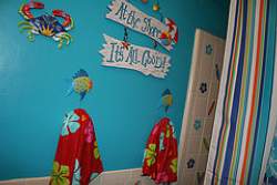 Cute undersea bathroom design for kids with fishy towel holders.