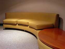 Picking a leather sofa style can be challenging; you have so many shapes and styles to choose from, like this very modern curved sofa with attached end table.
