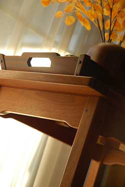 Dark colors and the natural grain of wood predominate in Mission style furniture and decor. Note the hint of natural color and warmth provided by the accent decoration placed on this side table.