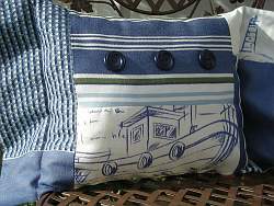 Throw pillows with embroidered or printed images of the sea or nautical elements will help pull your nautical room design together nicely.