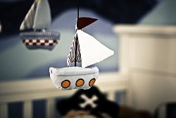 Something as simple as this sailboat mobile hung over a baby crib can infuse your room with a subtle feeling of the sea.
