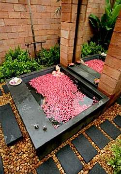 Natural stone makes a great material for an outdoor tub or jacuzzi area.