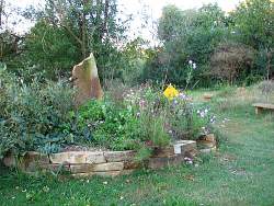 Natural rock planting beds work well in the prairie garden style, giving form and structure without detracting from the natural shape of your prairie garden layout.