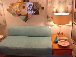 Pale green fabric accents this retro sofa, featuring plain shape and no arm rests.