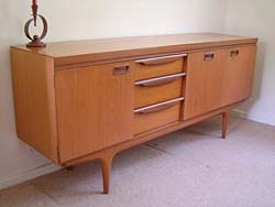 Wood veneer, sleek lines and chrome accents are typical features of retro furniture design as shown by this retro sideboard.