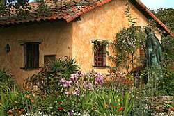 Choose a theme for your small yard; here a spanish style home looks natural with a Mediterranean style garden in the courtyard area.
