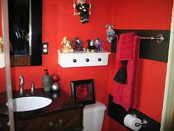 Color plays an important role in designing your teen bathroom. Red and black gives this teen bathroom great contrast and a bold theme.