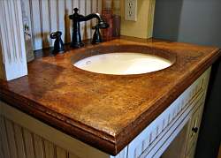A glazed concrete finish gives this bathroom vanity countertop the look of a natural patina that feels Tuscan.
