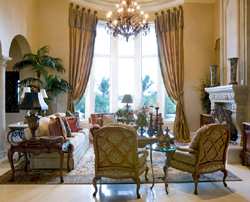 Formal draperies, left open to let in light and provide a grand view work well in this elegant, rich interior.