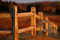 For a large country property, the classic split rail wood fence gives a rustic look.