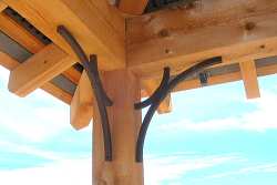 Details in this fine, crafted patio cover use wrought iron to echo and accent the patio furniture; a nice detail.